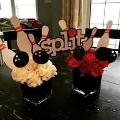 two vases filled with flowers sitting on top of a table next to each other