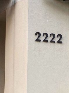 a clock on the side of a building with numbers 22 22 and 22 52 below it