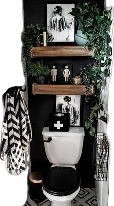 a black and white bathroom with shelves above the toilet, plants on the ledges