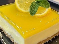 a piece of cheesecake with lemon and mint garnish