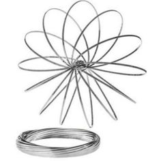 a wire sculpture sitting on top of a white surface next to a coil and ring