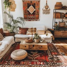 a living room filled with lots of furniture and rugs on top of a hard wood floor