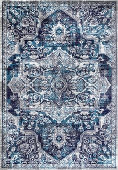 a blue and white rug with an ornate design