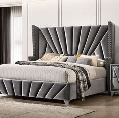 a bedroom with a bed, dressers and mirror in it's center area