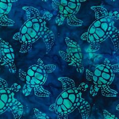 a blue and green tie dyed fabric with sea turtles on it