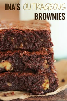 three brownies stacked on top of each other with walnuts in the middle and text that reads ina's outrageous