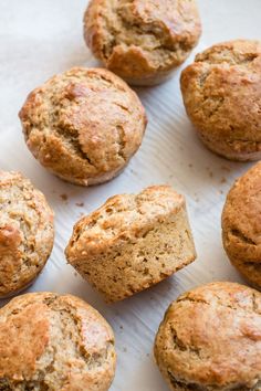 freshly baked muffins sitting on top of a white paper