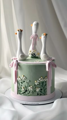 a cake decorated with three birds on top of it