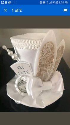 a white hat with pearls and lace on it