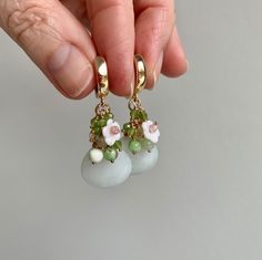 Beautiful refined earrings with floral details made of olivine, prehnite and strawberry quartz on luxurious earrings. Earrings: 18k gold filled Ball pins: 14k gold filled Wire around the jade briolette: gold nontarnish. These materials retain their color and shine even after a lot of wear. Please note: eau de toilette, perfume and hairspray do not make any earring look more beautiful. Put in your earrings after applying these products. Briolette Earrings, Sage Green Jewelry, Luxury Earrings, Jade Earrings, Green Jewelry, Strawberry Quartz, Jade Pendant, Jade, Beaded Earrings