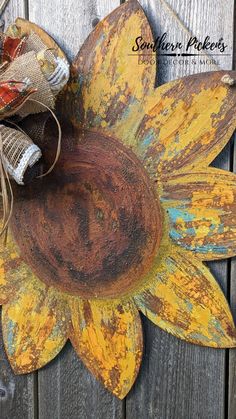 an old sunflower is painted yellow and has some burlocks on top of it