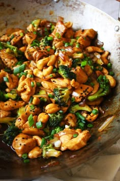 stir fried chicken and broccoli in a wok