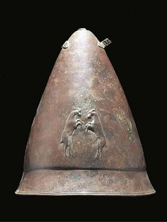 an old metal helmet with a horse on it