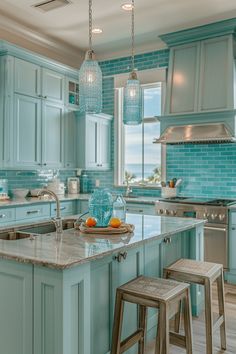 a kitchen filled with lots of blue cabinets and counter top space next to an island