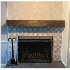 a fireplace with blue and white tiles on it