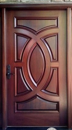 the front door is made from wood and has a decorative design on it's side