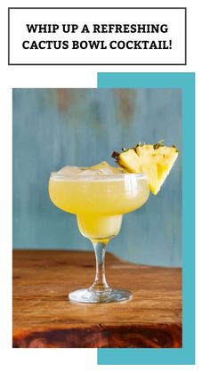 a glass filled with yellow liquid next to a piece of pineapple on top of a wooden table