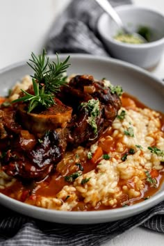 a white plate topped with meat and rice