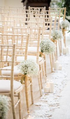 rows of chairs with flowers and candles on the floor in front of an open window