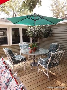 a patio table with chairs and an umbrella