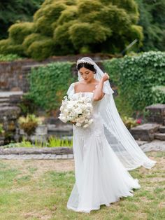 a woman in a wedding dress holding a bouquet