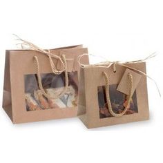 two brown paper bags with rope handles are sitting next to each other on white background