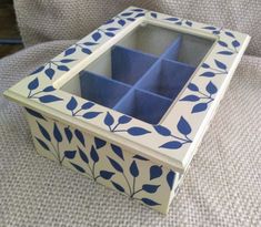 a blue and white box sitting on top of a couch