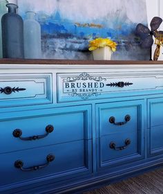 an old dresser painted in blue and white