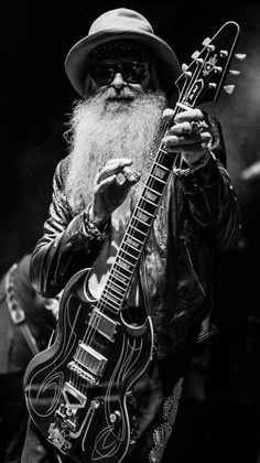 an old man with a long beard holding a guitar