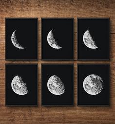 four framed photographs of the moon in black and white on a wooden table with wood flooring