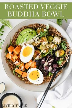 a white plate topped with an egg, meat and veggies next to a fork