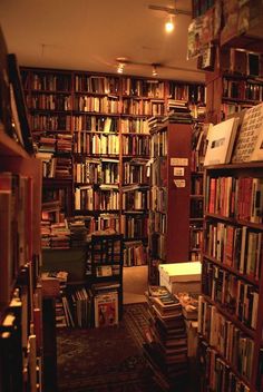 a bookshelf filled with lots of books in a room next to a doorway