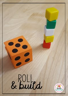 an orange and black dice sitting next to a wooden block on top of a table