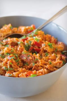 a white bowl filled with rice and meat