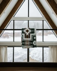 a window with a blanket hanging from it's side