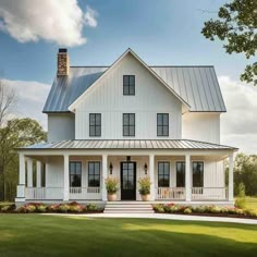 a white house with black shutters on the front porch and two storyed windows