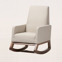 a white rocking chair with wooden legs and a beige upholstered seat, viewed from the front