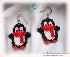 the beaded penguin earrings are made with black, white and orange seed stitchs