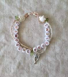 a bracelet with words and charms on it