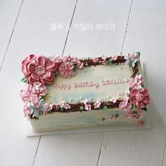 a birthday cake decorated with pink flowers on a table