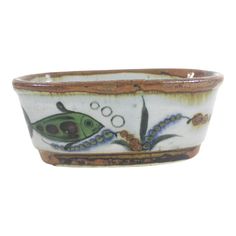 a ceramic bowl with an image of a fish and bubbles on the inside of it