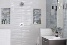 a bathroom with gray and white tiles on the walls