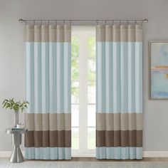 a living room with blue and brown curtains