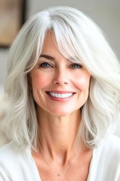 Save this pin for the best hairstyles for women over 60 with bangs. Soft layers give this mid-length style a voluminous look. Side-swept bangs soften the forehead and blend into the layers. Long Layers Side Bangs, Layers Side Bangs, Older Hairstyles, Hairstyles For Over 60, Long Layers With Bangs, Straight Across Bangs, Flapper Hair, Best Hairstyles For Women, Long Layered Cuts