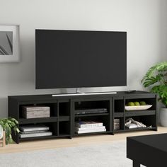 a flat screen tv sitting on top of a black entertainment center