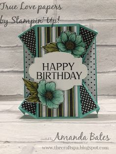 a happy birthday card with flowers and polka dots on the bottom, in front of a white brick wall