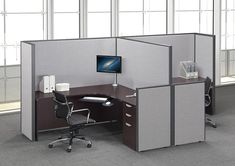 an office cubicle with two desks and chairs