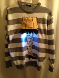 a striped sweater with an image of a man's head on it