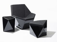 three black chairs and two stools on a white background