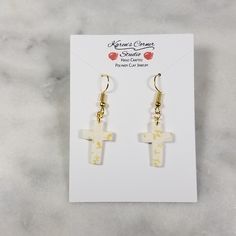 Made from polymer clay, these cross-shaped white earrings have a dainty overlay of a gold leaf pattern. They are simple, lightweight, and elegant. Perfect as a gift to others or yourself.They come from a smoke-free, pet-free home and are mounted on hypoallergic wires. They can also be purchased with a clip-on finding for those who do not have pierced ears. Clay Cross Earrings, Polymer Clay Cross Earrings, Cross Clay Earrings, Clay Cross, Gold Clips, White Crosses, Cross Earrings, White Earrings, Polymer Clay Creations